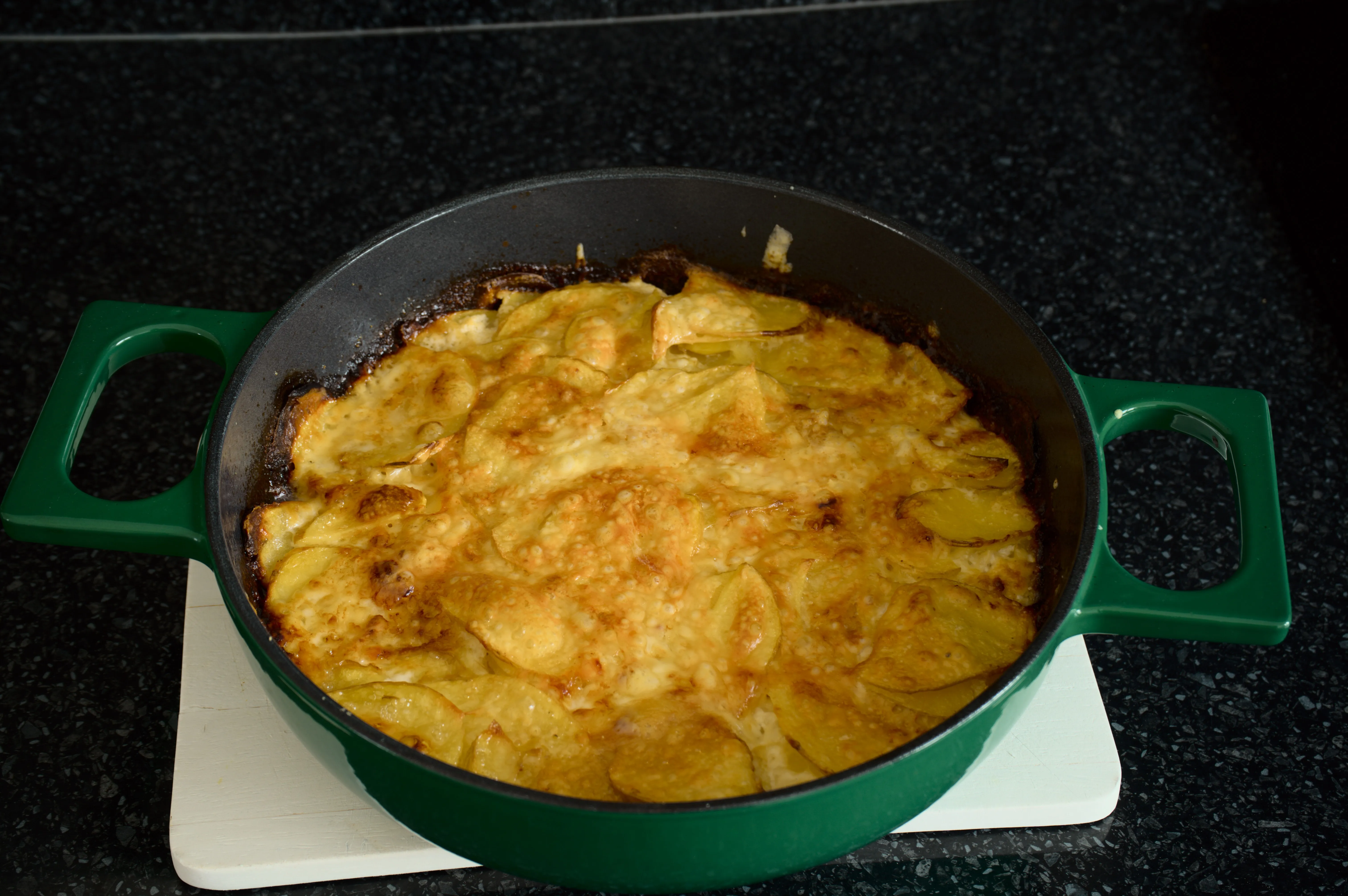 Finished potato and zucchini gratin, deeply golden in its baking dish