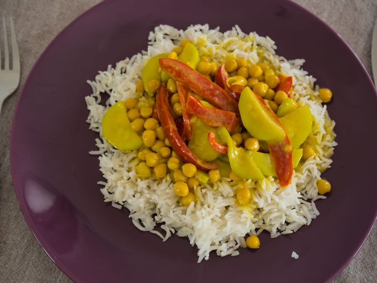 Vegetarian coconut zucchini and chickpea curry with red pepper served over white rice