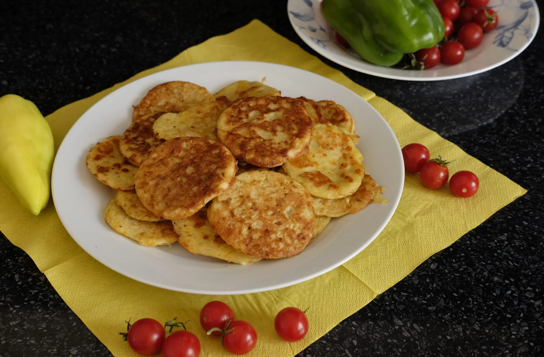 Plate of small browned potato and zucchini fritters