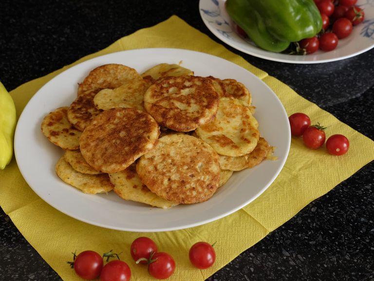 Plate of small browned potato and zucchini fritters