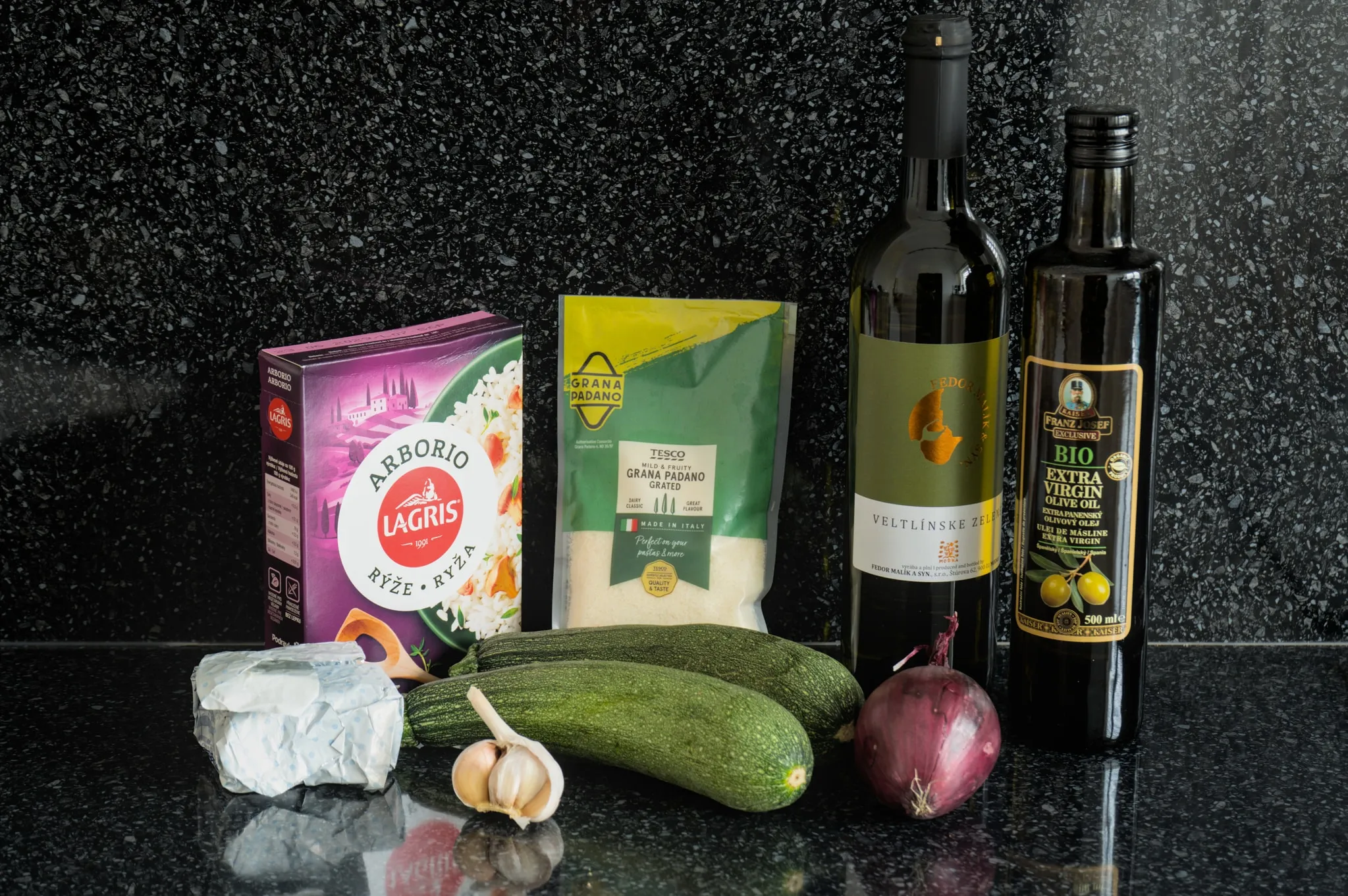 Arborio rice, Parmesan, dry white wine, olive oil, butter, zucchini, garlic and red onion prepared for zucchini risotto