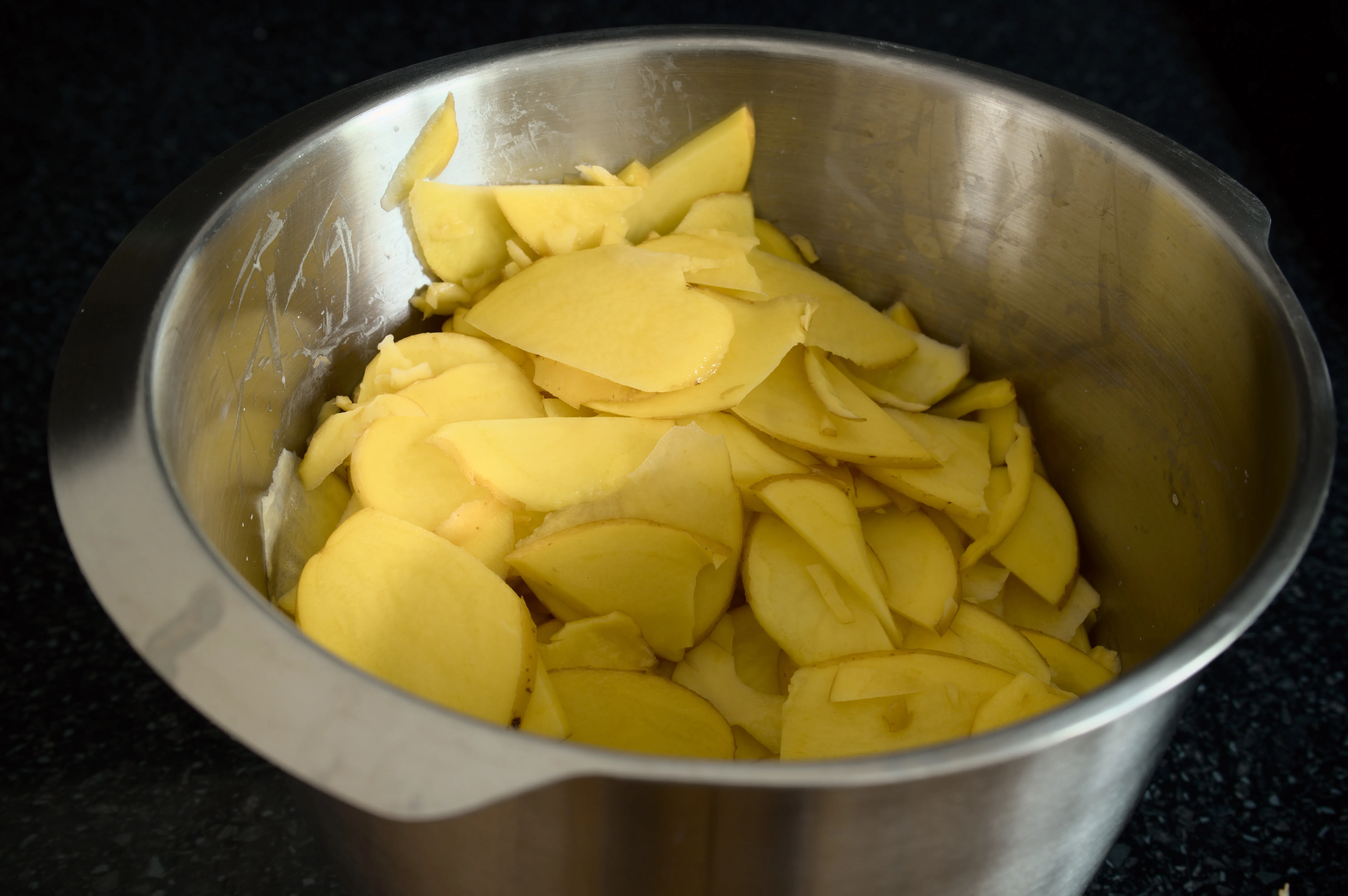 Washed young potatoes with skin sliced into thin rounds