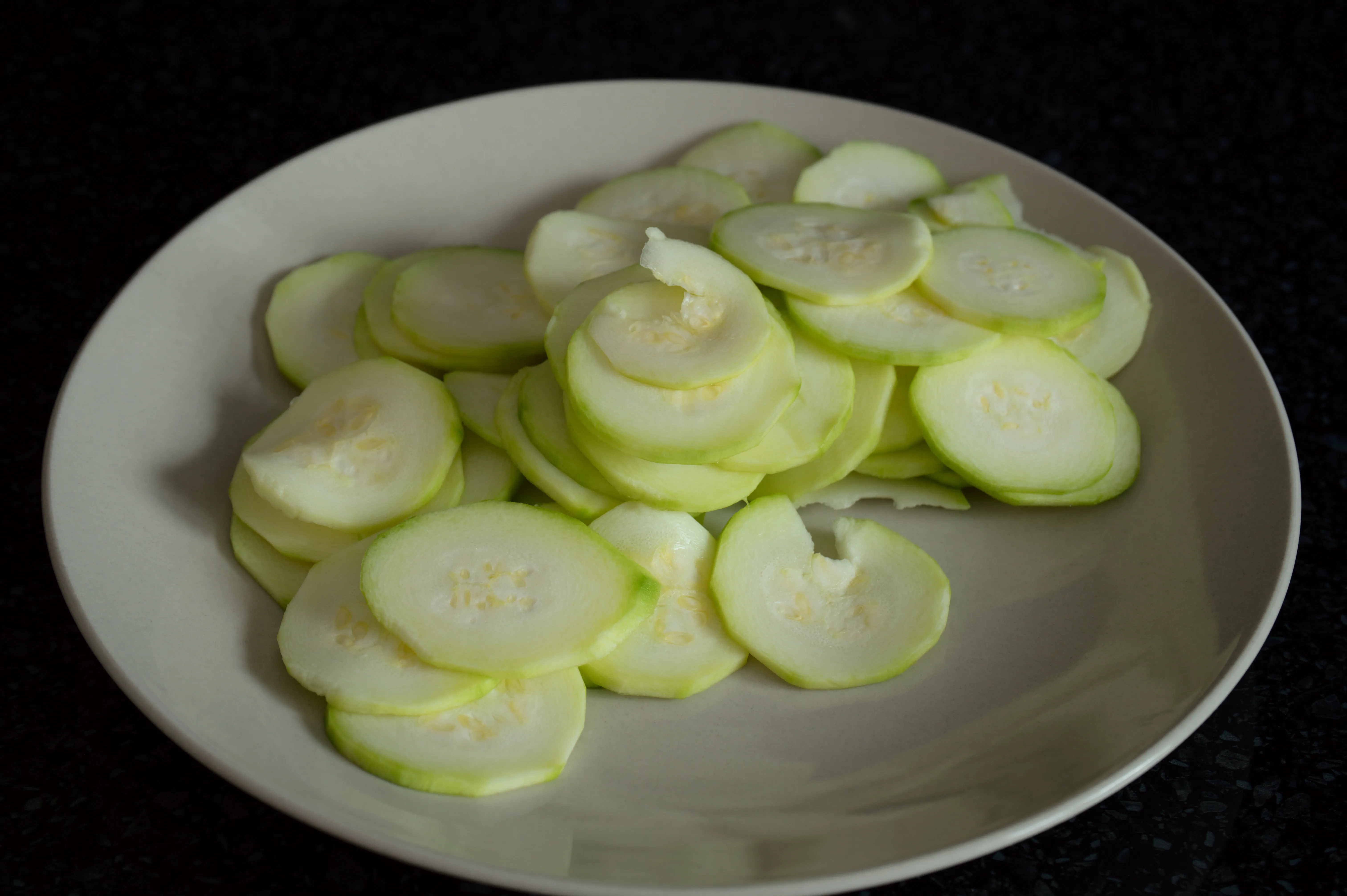 Peeled zucchini sliced into thin rounds