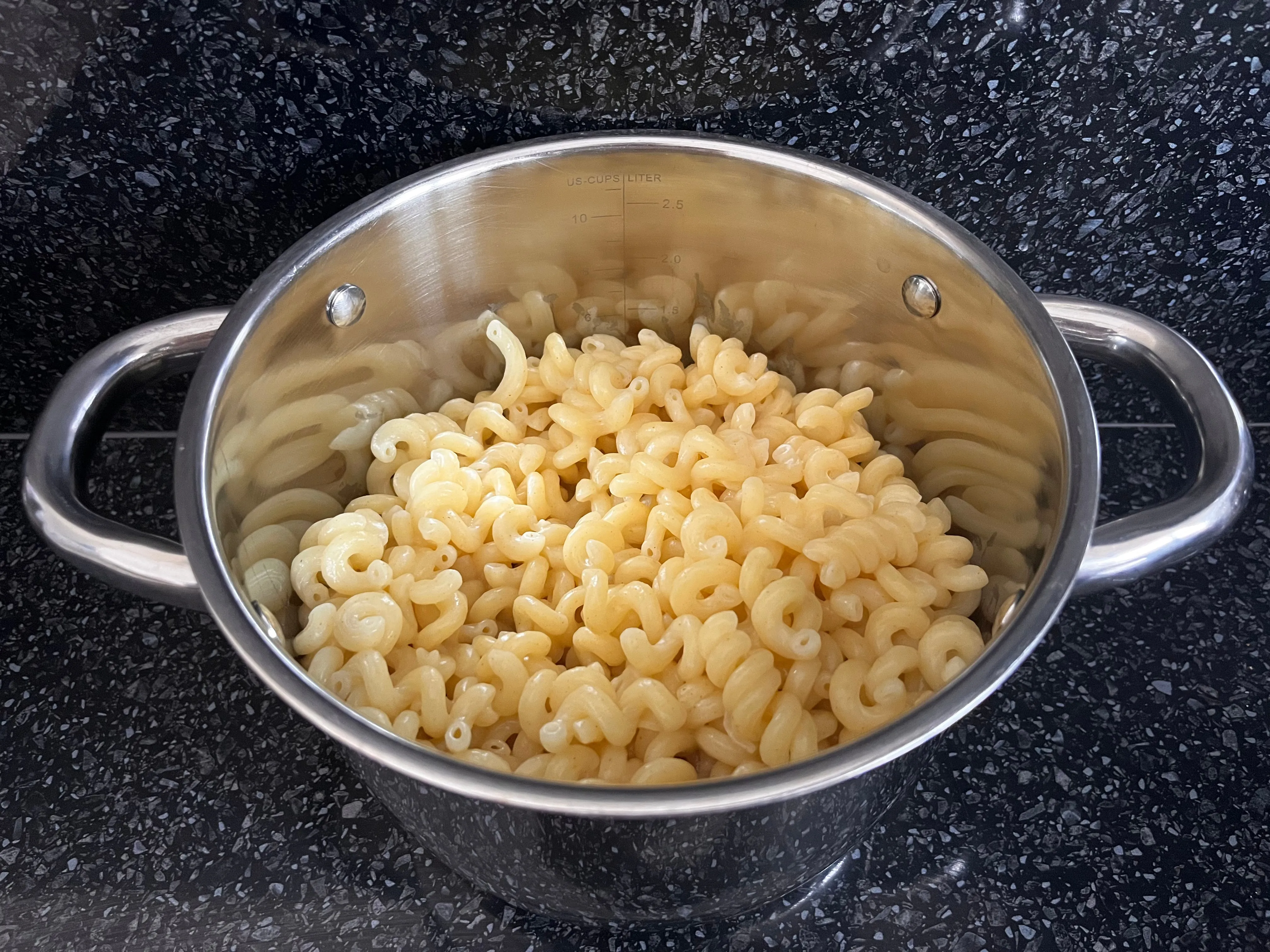 Cooked and drained elbow macaroni in a pot